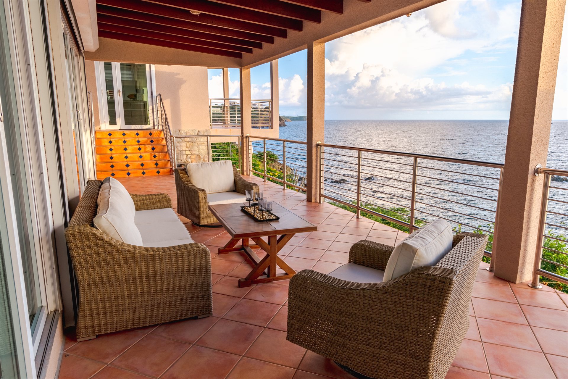 Outdoor lounge and patio with Caribbean Sea views at Ocean Pointe Caribe, St Thomas USVI