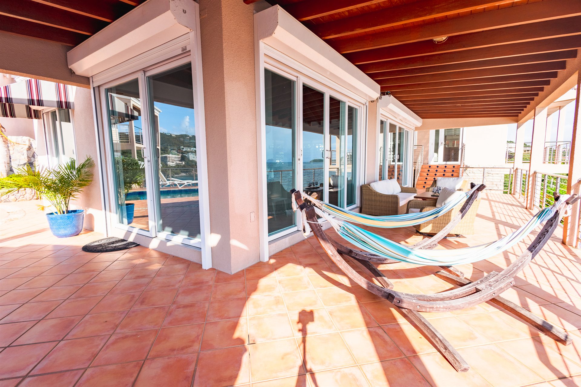 Covered veranda with sweeping ocean views at Ocean Pointe Caribe luxury estate